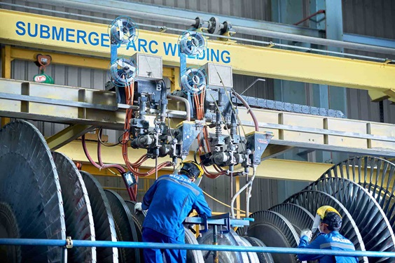 Sulzer employees welding a turbine rotor