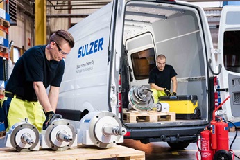 Two men loading a maintenance van